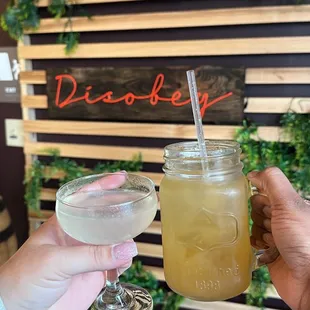 two people toasting with drinks