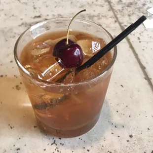 a drink with a cherry on top