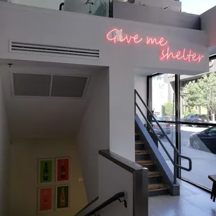 a neon sign that reads give me shelter