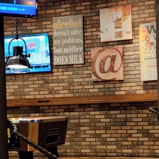 Sassy signs near pool table