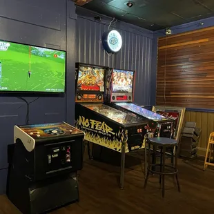 a row of pinball machines in a game room