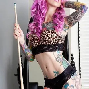 a woman with pink hair and tattoos