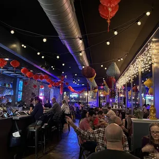 a crowded restaurant with people sitting at tables