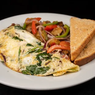 an omelet with toast and vegetables