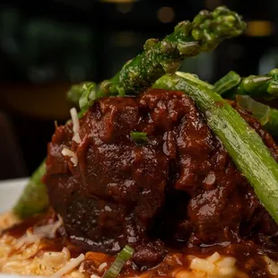 a plate of meatballs and asparagus