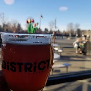 a hand holding a glass of beer