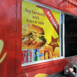 a red food truck with a menu on the side