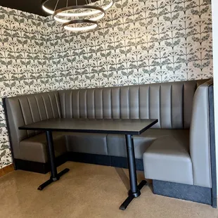 a booth with a table and two chairs