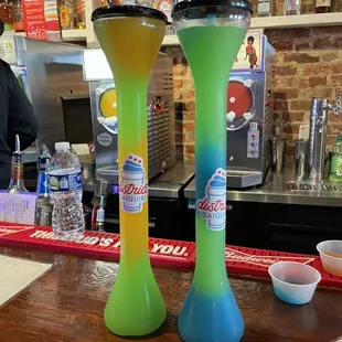 two tall vases on a bar