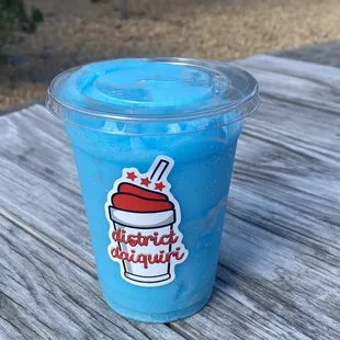 a blue drink with a straw
