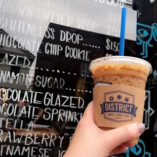 a hand holding a cup of coffee