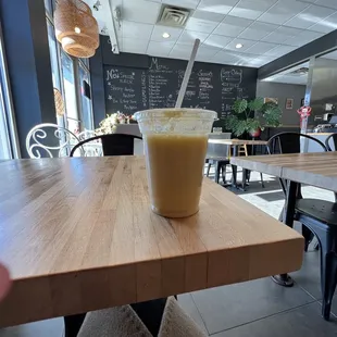 Mango and soy milk on a table looking at the menu of dumplings