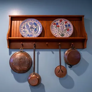 pots and pans hanging on a wall