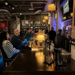 a group of people sitting at a bar