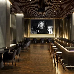 a long dining room with tables and chairs