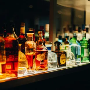 a row of liquor bottles on a shelf