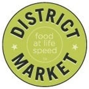 a green circle with the words district market