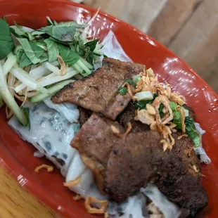 a plate of beef and noodles