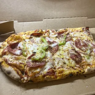 Pepperoni Pizza with onions and bell peppers.