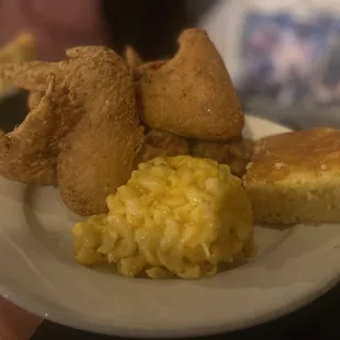 a plate of fried chicken, scrambled eggs, and cornbreads