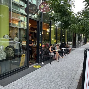 people sitting outside a coffee shop