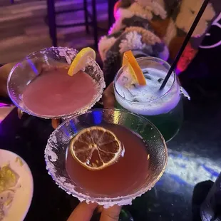 a close up of three cocktails
