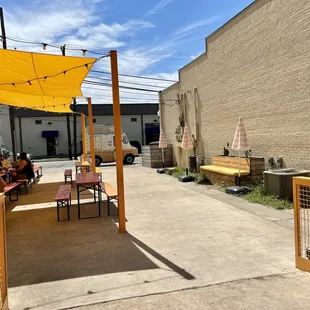 a patio area with tables and umbrellas