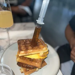 a stack of waffles with a knife sticking out of it