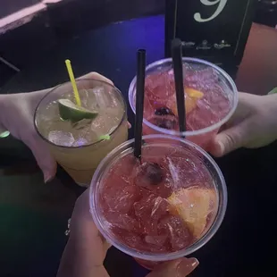 two drinks in plastic cups with straws