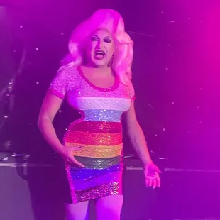 a woman in a colorful dress on stage