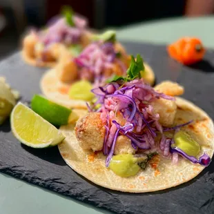 Crispy Fish Tacos w/ breaded cod, tajin slaw, avocado crema, flour tortilla | 3 pc-$16