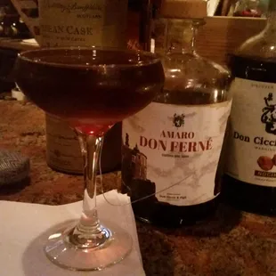 a glass of wine and a bottle of liquor