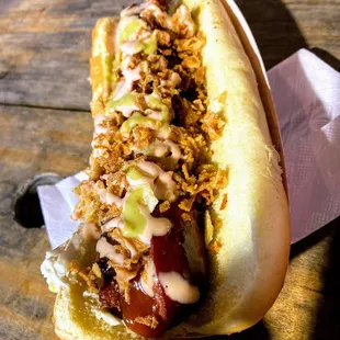 a hot dog covered in condiments