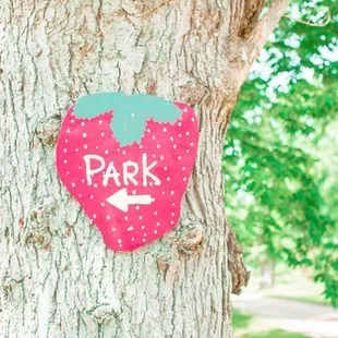 a park sign on a tree