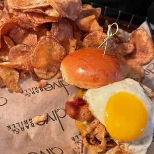 A burger with a perfectly cooked egg and house made chips