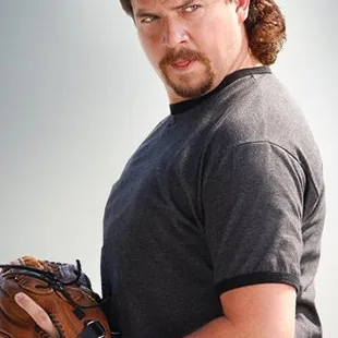a man in a baseball uniform holding a catchers mitt
