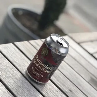a can of beer on a wooden table
