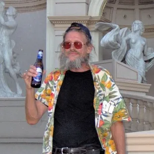 a bearded man holding a beer