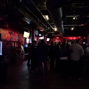 a crowd of people sitting at the bar
