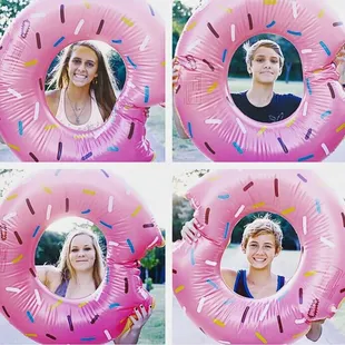 a woman holding a pink inflatable donut