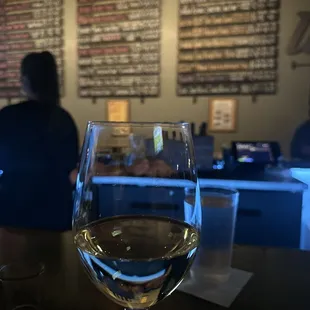 a glass of wine on a bar