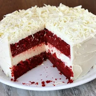a red velvet cake with white frosting