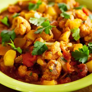 a green bowl filled with food