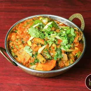 a bowl of food on a wooden table
