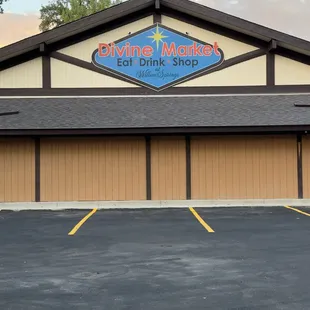 Divine Market logo above the parking lot.