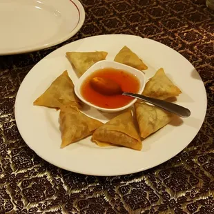 Golden Triangles appetizer with sweet and sour sauce