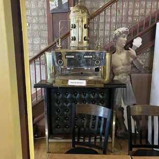 Espresso machine and stairs to upstairs.