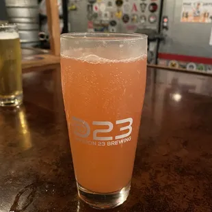 a glass of beer on a bar