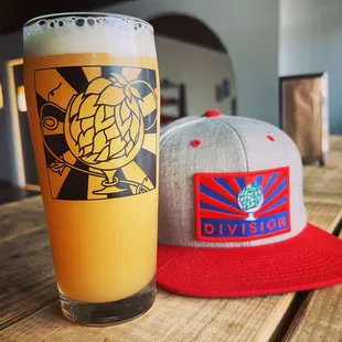 a glass of beer and a hat