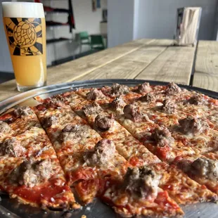 a pizza and a glass of beer